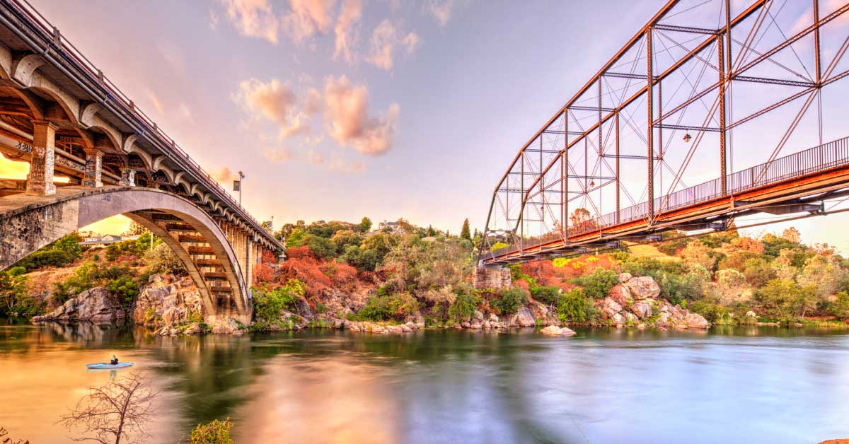 Rainbow Bridge and the historic Folsom truss bridge over the American River at sunset