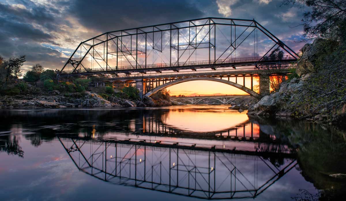 Historic Folsom truss bridge over the American River at sunset